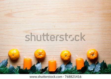 New Year`s and Christmas mockups with mistletoe, oranges and candle on wooden background flat lay