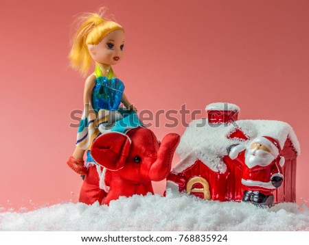 Snow house with Santa and a little doll girl ride on the elephant