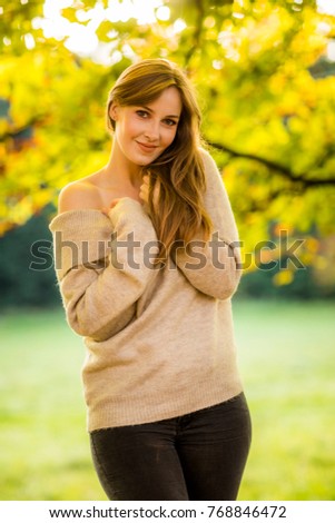 portrait of a brunette young independent happy woman in autumn park happy thoughtful spring autumn mood at golden hour