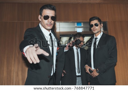 bodyguards stopping paparazzi when celebrity going out from elevator 