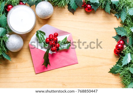 New Years and Christmas decorations, balls, gifts, boxes, packaging, handmade toys, oranges, mistletoe, candles, preparing for the holiday, letters, greeting cards on wooden background flat lay