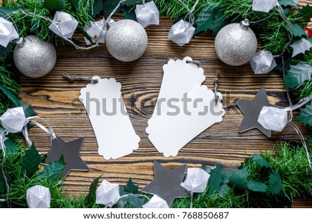 New Years and Christmas decorations, balls, gifts, boxes, packaging, handmade toys, oranges, mistletoe, candles, preparing for the holiday, letters, greeting cards on wooden background flat lay