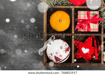 Boxes with gifts for Christmas and various attributes of holiday on a dark background. Top view, copy space. Snow
