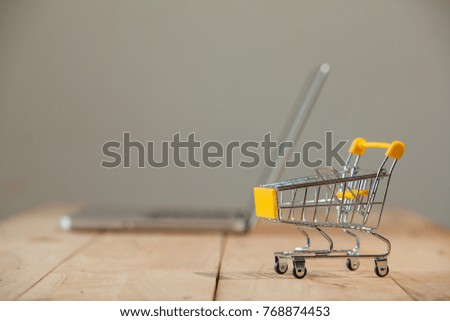 Small Shopping Cart On Laptop With Copyspace : Online Shopping Concept. E-commerce.