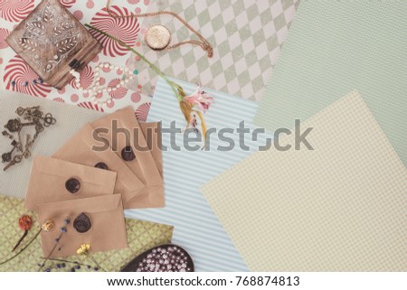 top view of envelopes and jewelry box over pack paper background