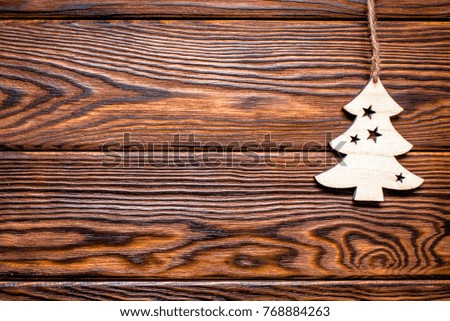 Christmas toy lies on a brown wooden background 