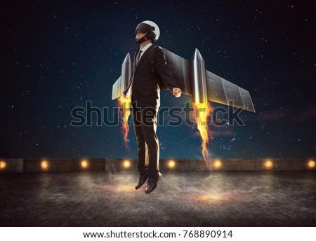 Businessman wear a rocket suit to lift , Business success concept . Royalty-Free Stock Photo #768890914