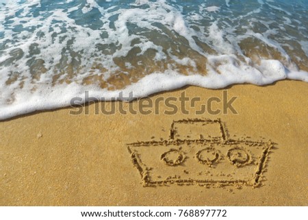 Picture of a ship on the golden sand of the beach. Vacation on a cruise ship. Waves with foamy blue ocean on a golden sunny sandy beach at the resort. 
