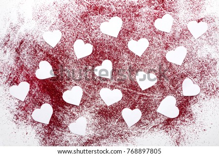 Valentine's day card. White paper hearts on glint red background.