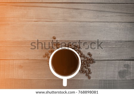 Cup of coffee on wood background.Top view