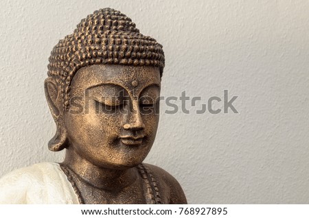 Siddhartha bronze statue. Close up of Buddha beautiful serene face with closed eyes. Best meditation inspiration image or mindfulness background.Copy space.