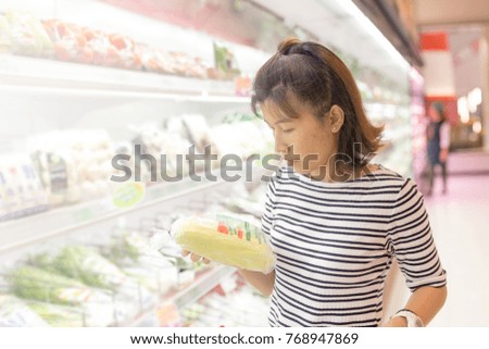 Asian women shopping for vegetables in supermarkets.