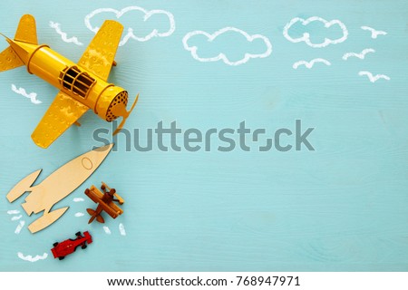 Concept of imagination, creativity, dreaming and childhood. Old toys: car, rocket and plane with info graphics sketch on the blue background