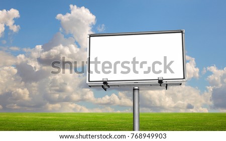 Empty billboard in a field with a blue sky 