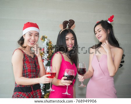 Christmas party, Young beautiful Asian Woman friends having fun, dancing and drinking cocktails for holiday background. Party and celebration concept.