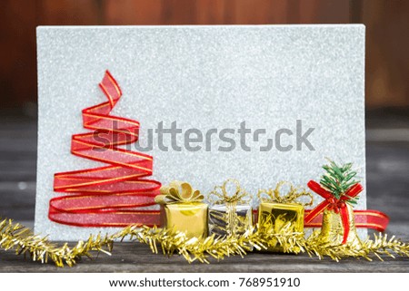 Christmas concept, gold and silver gift box with Christmas decoration over blurred silver glitter paper background