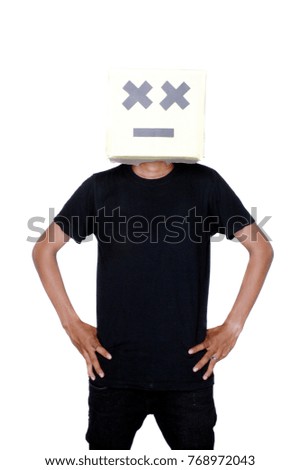 young boy standing with his face from cardboard boxes against white background