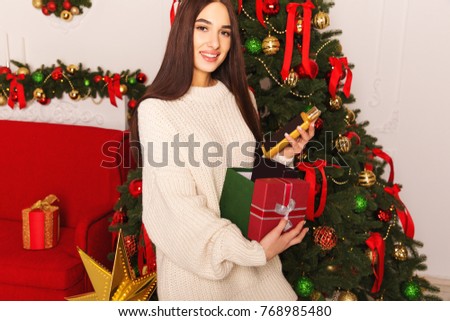 Happy girl with presents shampoo and others beauty care things. Christmas girl with present.