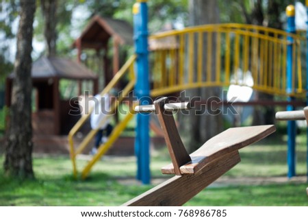 one side wooden seesaw board at play ground