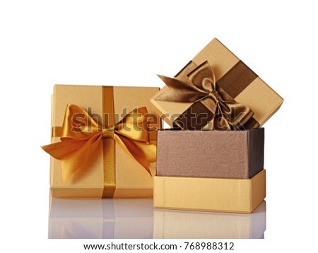Two golden classic shiny gift boxes with brown satin bows isolated on white background