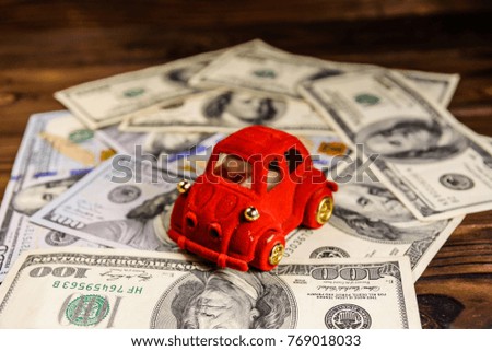 Toy car on one hundred dollar bills