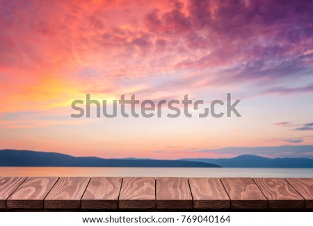 Empty wooden table with beautiful sunset background
