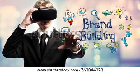 Brand Building text with businessman using a virtual reality headset