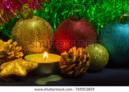 Colorful Christmas decoration and scented candle on the table.