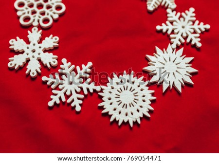 Snowflakes on a red background. Christmas toy drive. Beautiful photo