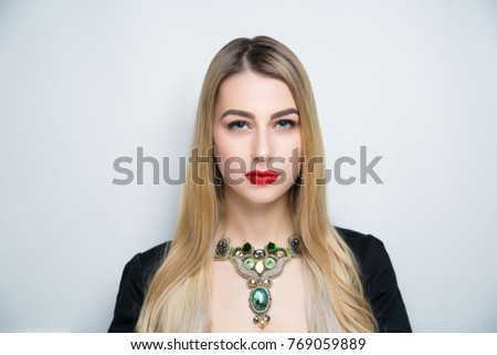 Close-up portrait of beautiful girl pretty lady with professional makeup, arrows long lashes, blond hair styling. Luxury New Bright color make-up shiny lipstick glossy cosmetics. photo conceptual idea