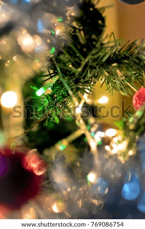  Christmas tree branch with glowing blurred lights in the background