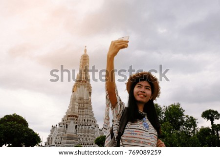 
Beautiful Asian woman selfie with wat Arun temple on vacation