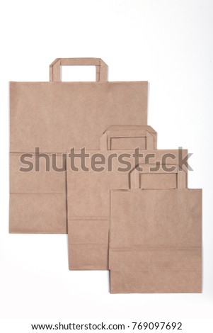 Different size beige brown kraft paper bag with handles top view flat layed. Mockup