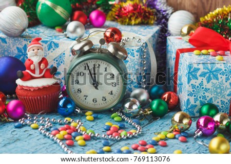 Christmas cupcake with colored decorations Santa made from confectionery mastic, soft focus background