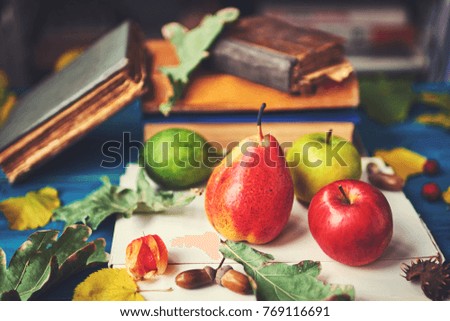 still life with fruit and books. Soft focus
