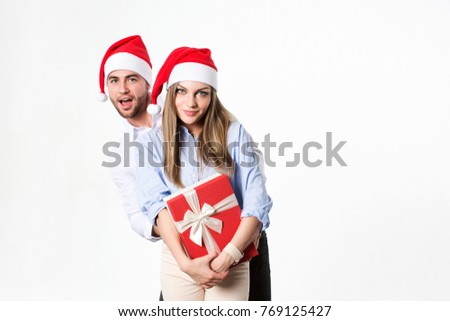 Holiday. Christmas holiday couple smile hold gift box present.