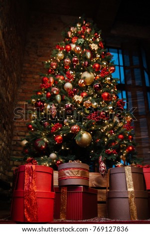 A lot of gifts under the Christmas tree. Christmas Eve.
