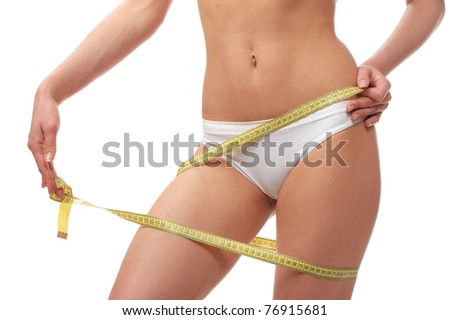 Perfect shape young woman measuring of beautiful hips with a measuring tape on a white background