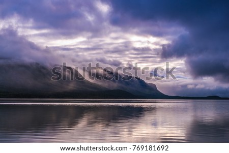 Amazing view of beautiful landscape with mountains, clouds and reflection in the water. Artistic picture. Beauty world 
