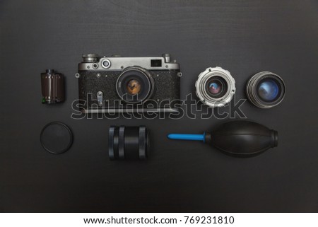 Vintage Film Camera And Accessories On Black Wooden Background Technology Development Concept. Top View