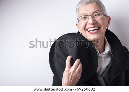 Happy smiling senior old woman with style and class Royalty-Free Stock Photo #769250602