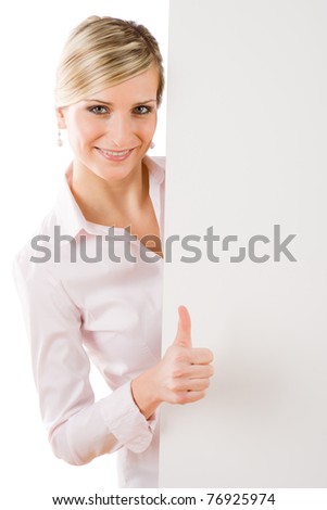 Happy businesswoman behind blank advertising banner thumbs up