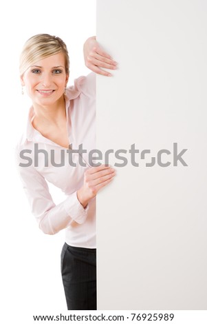 Happy businesswoman behind blank advertising banner standing