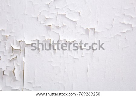 The ceiling is painted white and there is a gliding of paint that is caused by moisture.