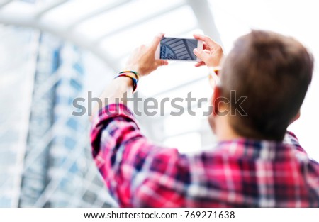 Young Man Taking Photo Smartphone Concept