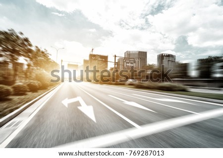 blurry view of empty asphalt road in midtown of hangzhou in sunny cloud sky