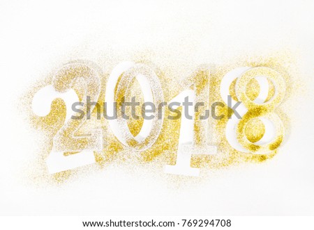 Luxury glowing numbers 2018 made from gold shiny glitter. New year concept. Text space