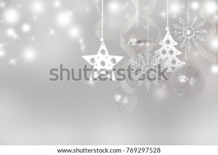 Christmas holiday composition. Festive creative white silver pattern, xmas decor holiday ball with ribbon, snowflakes, xmas tree on white background whith bokeh. Flat lay, top view