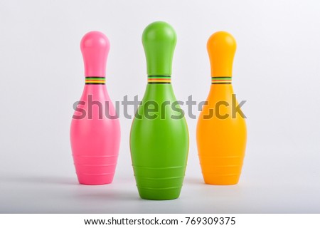 Colorful plastic skittles of toy bowling isolated on a white background