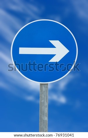 Arrow sign against deep blue sky